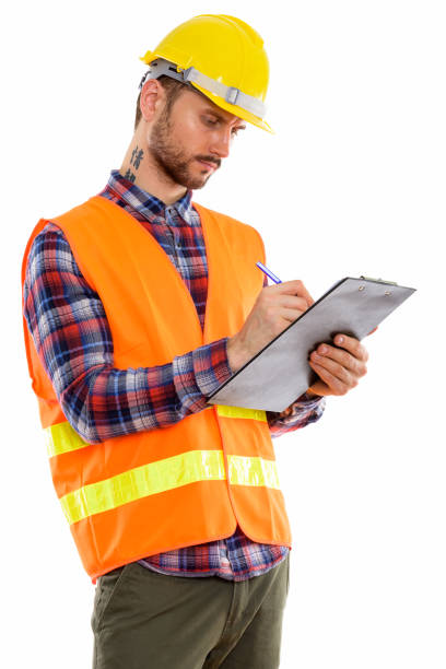 istock Studio shot of young man construction worker writing on clipboard 670060658