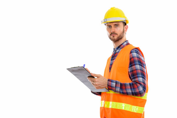 istock Studio shot of young man construction worker writing on clipboard 670060704