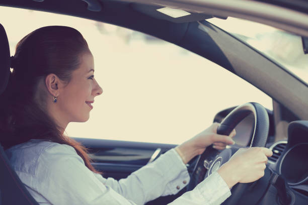 istock young woman driving a car 670061316