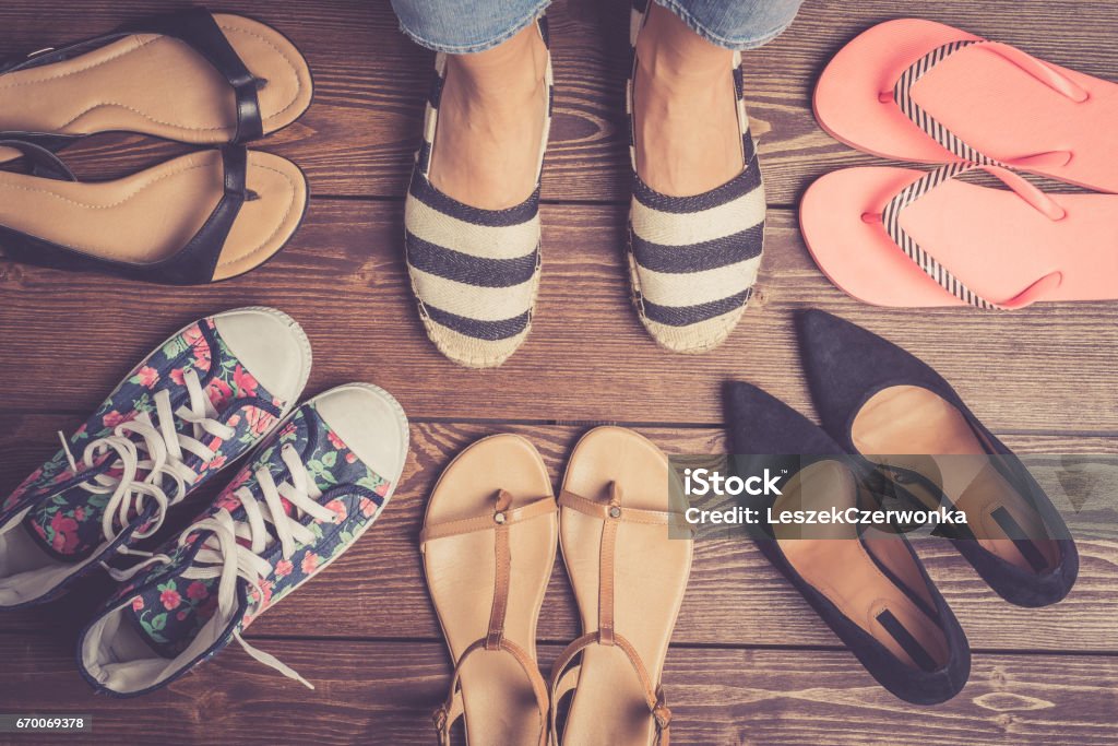 Collection of female shoes on wooden floor. Collection of female shoes on wooden floor. Fashion background Shoe Stock Photo