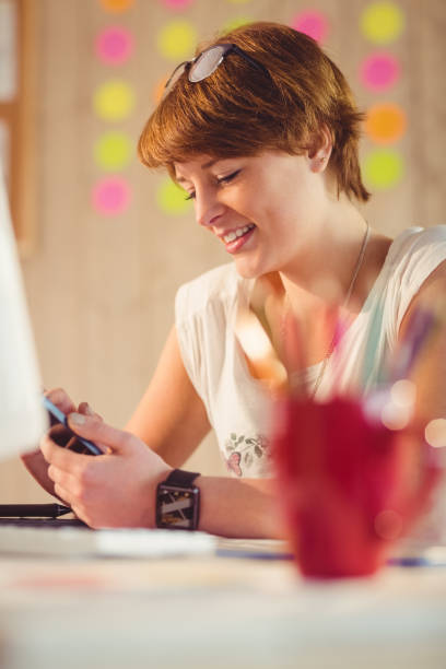 istock Casual businesswoman using her smartphone 670069458