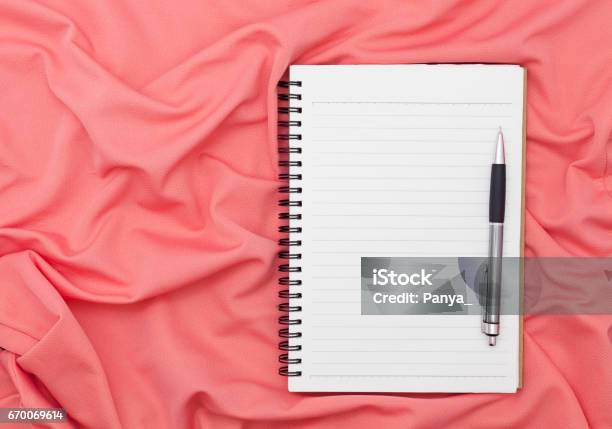Blank Paper Notebook With Pen On Beautiful Pastel Silk Background Stock Photo - Download Image Now