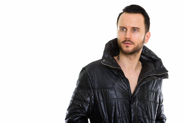 Studio shot of cool young man thinking while looking at distance horizontal shot