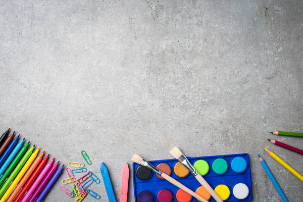 istock School supplies on gray stone background 670073074