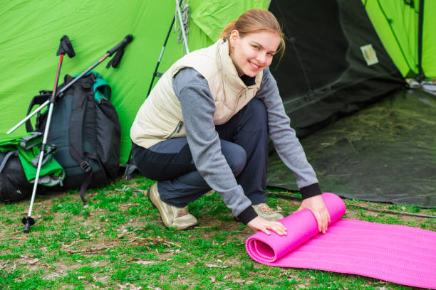 istock hiker puts up an inventory for camping 670073184