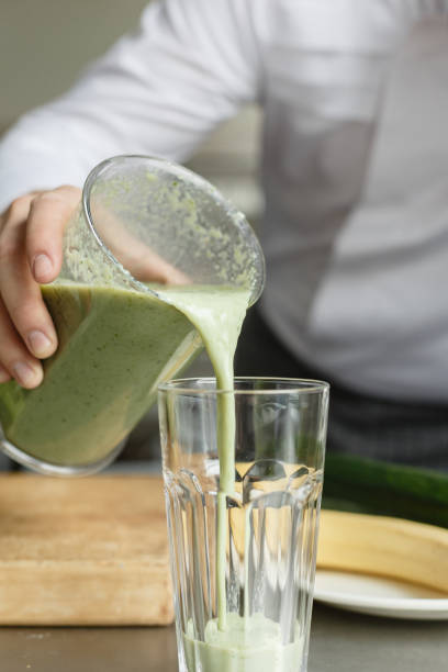 istock Male cooking fresh vegetable smoothie 670076284