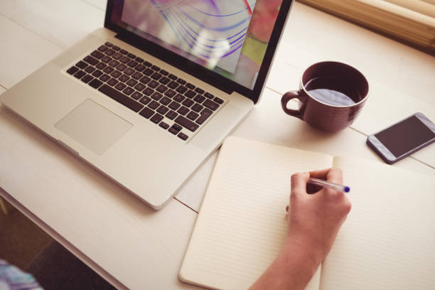 istock Businesswoman using her laptop at desk 670076918