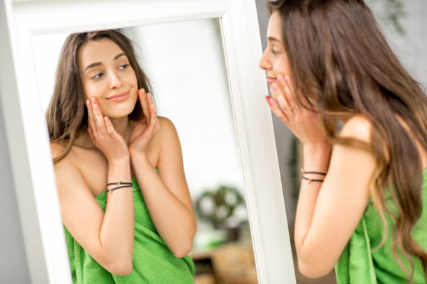 istock Woman looking at mirror in the bathroom 670076970