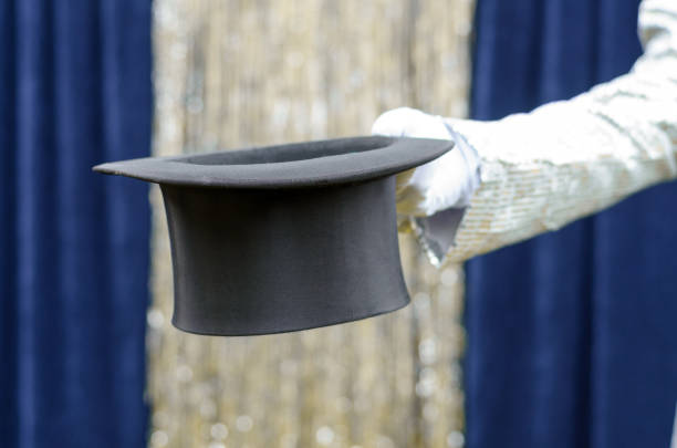 istock Gentleman or magician holding out a top hat 670077118