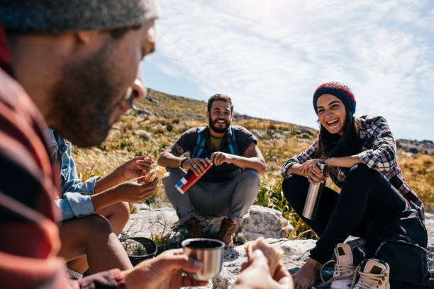 istock Group of people relaxing and eating during hike 670079366