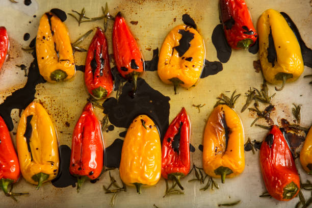 istock red and yellow pepper fried in oil 670083602