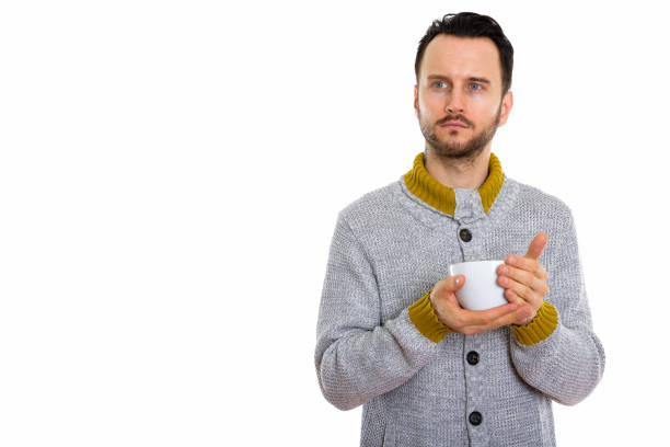 istock Studio shot of young man holding coffee cup while thinking 670083678