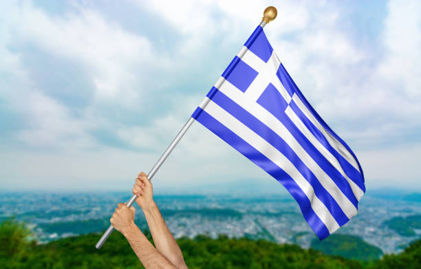 Man holding the national flag of Greece high in the air. The flag and pole have been realistically 3D rendered.