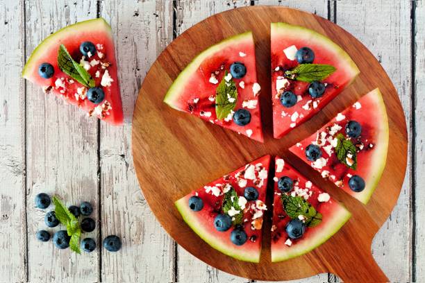 istock Watermelon pizza with blueberries, feta and mint on serving board 670084810