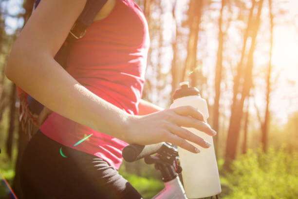 istock Young woman riding a bicycle in the forest 670095684