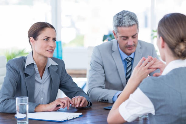 istock Business people interviewing young businesswoman 670096178