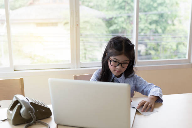 istock Beautiful student school girl studying online, learning, writing notes in a desk at home 670101970