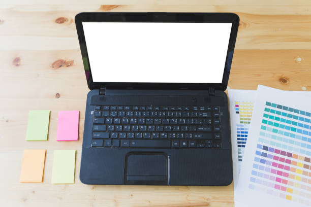 istock graphic designer desk table with computer, sticky note and color guide palette swatches 670102022