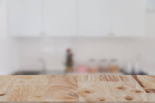 istock blurred white kitchen bench interior with selected focus wood table for montage or display your product 670102030
