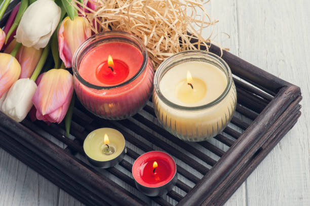 istock Yellow and pink aroma candles with tulips 670106582