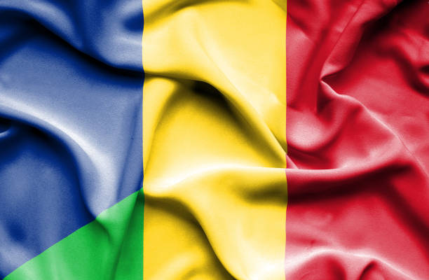 istock Waving flag of Mali and Romania 670112564
