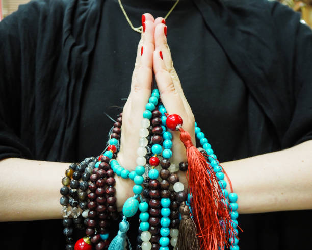 istock Rosary beads in namaste 670113160