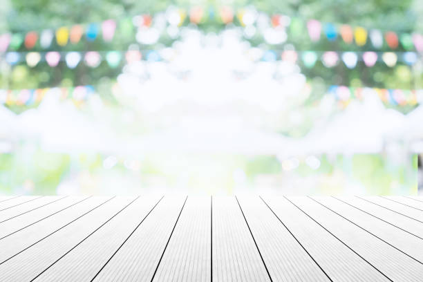 istock Empty wooden table with party in garden background blurred. 670113654