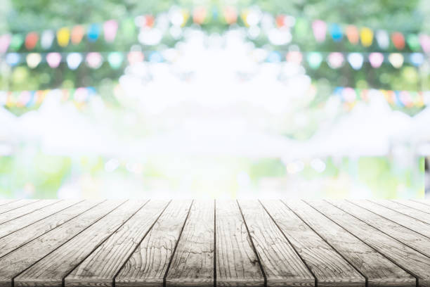 istock Empty wooden table with party in garden background blurred. 670115972