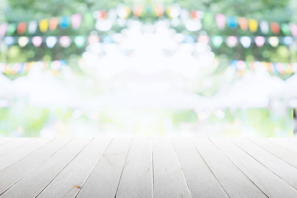 istock Empty wooden table with party in garden background blurred. 670116116