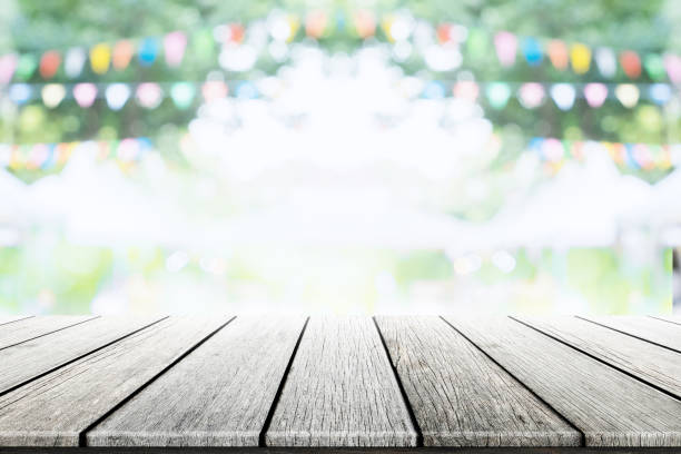 istock Empty wooden table with party in garden background blurred. 670116300