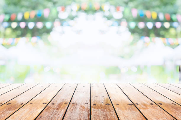 istock Empty wooden table with party in garden background blurred. 670116474