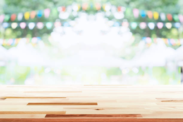 istock Empty wooden table with party in garden background blurred. 670116616