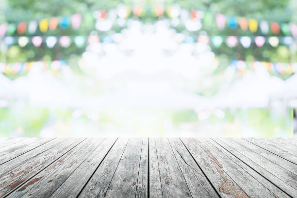 istock Empty wooden table with party in garden background blurred. 670117494