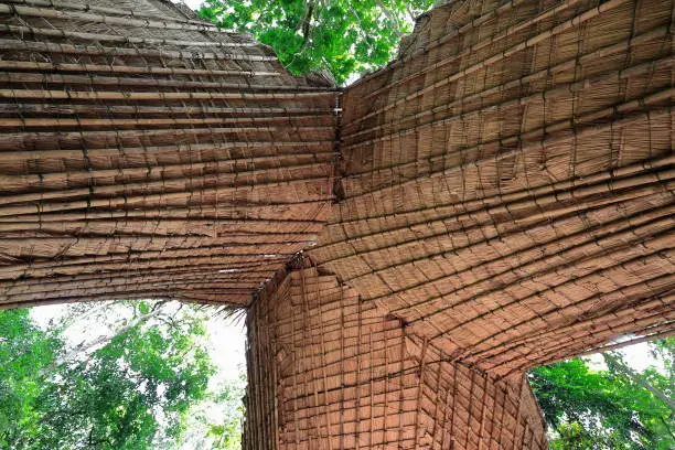 Structure made of long bamboo stems interwoven with fibers covering a concession stand on the hiking up way to the 50-60 ms.high Tat Kuang Si-Deer Dig falls 29 kms.-18 miles SW.of Luang Prabang-Laos.