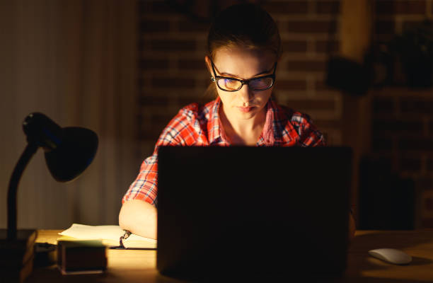 istock young woman student working on the computer at night 670117904