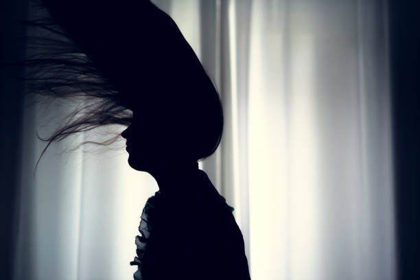 istock women hair silhouette at window 670120122