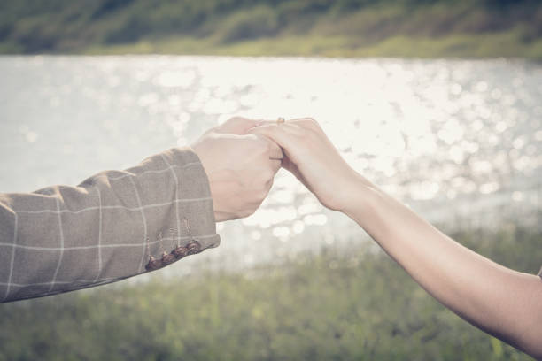 istock Love - romantic couple holding hands, beach sunset 670122212