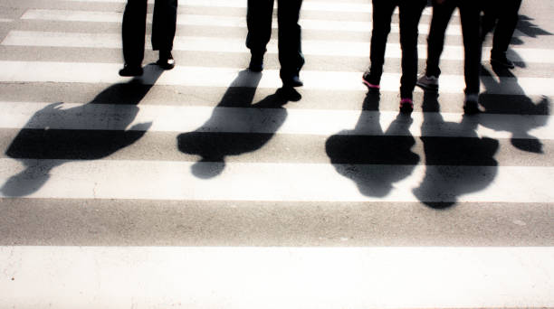 istock Blurry zebra crossing with  people silhouettes and  shadows 670122902