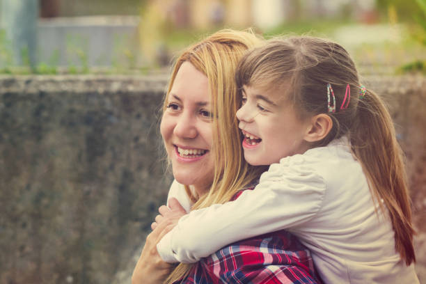 istock Happy mother carrying daughter around shoulders 670123394