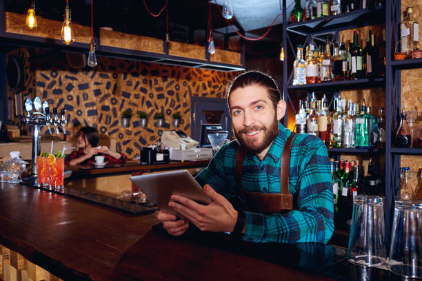 istock The barista barma with a tablet is smiling at  workplace in  bar 670123590