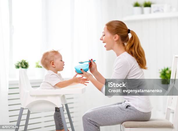 Mother Feeds Baby From Spoon Stock Photo - Download Image Now - Baby - Human Age, Mother, Feeding