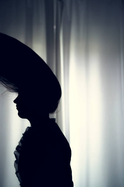 istock women hair silhouette at window 670126108