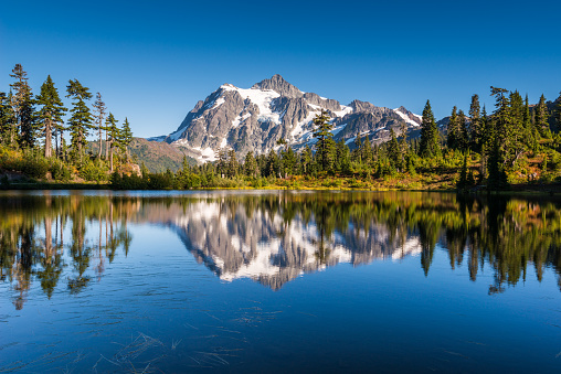 One of the classic landscape views in Western Washington is found on the shores of Picture Lake on the flank of Mount Baker, showing the reflected view of Mount Shuksan in the nearby North Cascades National Paek