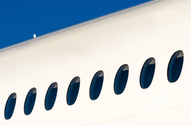 istock Portholes on white modern airplane and sky 670127028