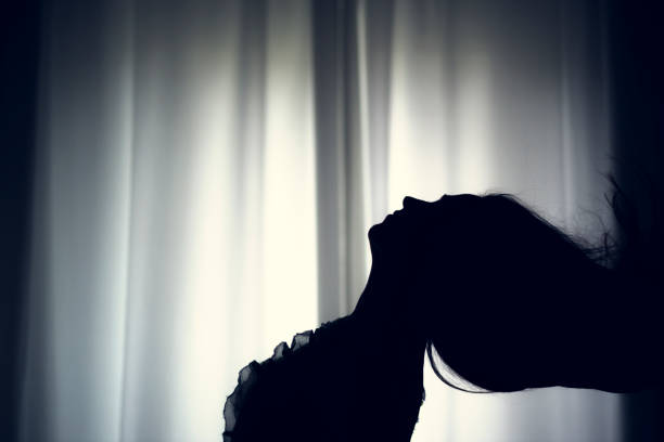 istock women hair silhouette at window 670127042