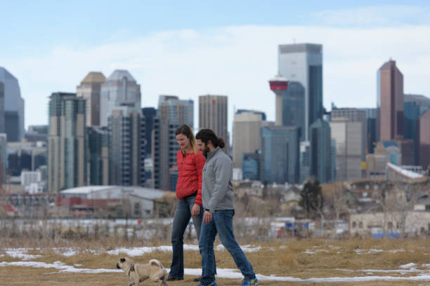 istock Attractive Interracial Couple Having Fun On a Cool Day with Healthy Pug 670129406