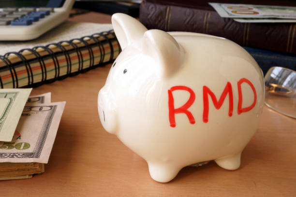 istock Piggy bank with word RMD. Retirement concept. 670130992