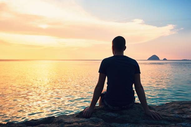 contemplation at the sunset - men beach back rear view imagens e fotografias de stock