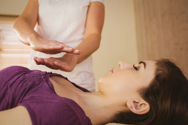istock Young woman having a reiki treatment 670134062