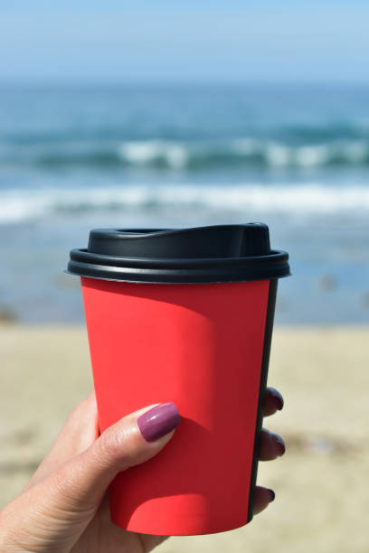 istock woman holding a coffee 670134210